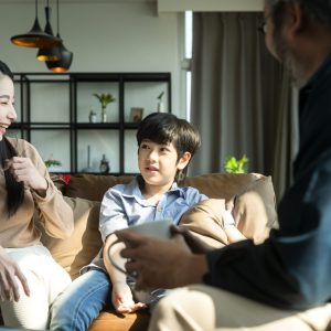Asian family sit relax positive conversation with son, happiness smile boy casual talking with his parent,Happy Asian family enjoy holiday together at sofa, home sweet home living room